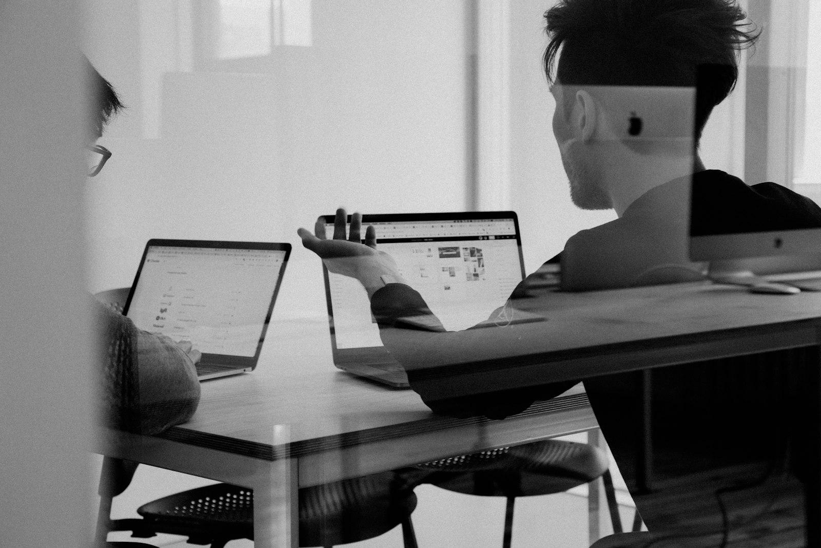 Consultants reviewing work through glass in a quiet office