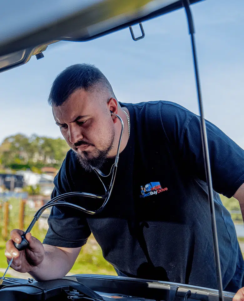 Inspect Buy Drive mechanic inspecting a car engine